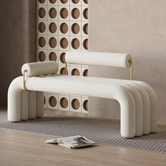 a white bench sitting on top of a hard wood floor next to a magazine rack