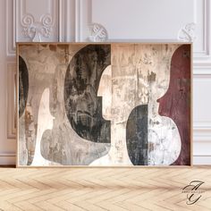 an abstract painting on the wall in a room with wood flooring and white walls