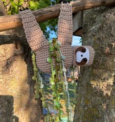 a stuffed animal hanging from a tree branch