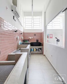 a kitchen with pink tiles and stainless steel appliances