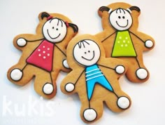 three decorated cookies with children's faces on them are sitting next to each other