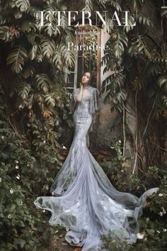 a woman is standing in the middle of some plants