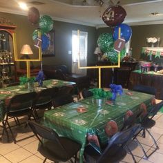 a football themed birthday party with balloons and table cloths on the dining room table