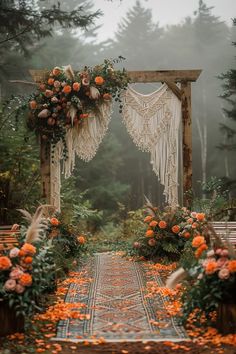 an outdoor wedding ceremony setup with flowers and macrame hanging from the arch, surrounded by greenery