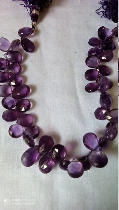 One Line 8.5''Natural African Amethyst Faceted Pear Shaped Amethyst Gemstone beads Stone :Natural African Amethyst Shape :- Faceted pear Weight :- 128 carat,Approx -Length - 8.5 inch, Size - 7x11mm Weight :- 111 carat,Approx -Length - 8.5 inch, Size - 7x10mm Polish :- Handmade Purity :- 100% Natural Gemstone color - blue makes a great gift for your loved ones. It is known as the 'love stone' as the message it emits is the strong vibration of unconditional love, joy, warmth and healing. As quartz Amethyst Gemstones For Jewelry Making In Teardrop Shape, Handmade Amethyst Beads For Jewelry Making, Purple Beaded Gemstones For Jewelry Making, Beaded Purple Gemstones For Jewelry Making, Handmade Teardrop Amethyst Gemstones, Handmade Amethyst Teardrop Gemstones, Carnelian Bracelet, White Tassel, 108 Bead