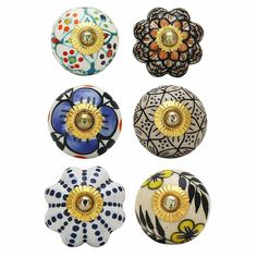 six decorative knobs with different designs and colors are shown in the image on a white background