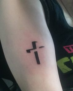 a cross tattoo on the left arm