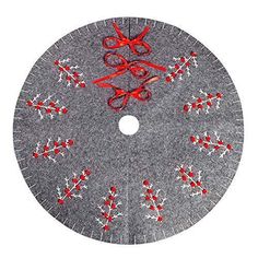 a grey christmas tree skirt with red and white snowflakes on the bottom, decorated with scissors