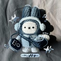 a crocheted stuffed animal with headphones on it's ears and hands