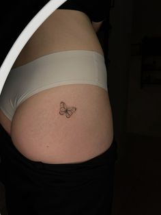 a woman with a butterfly tattoo on her stomach