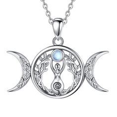 an image of the moon and crescent pendant on a white background with a blue stone in the center