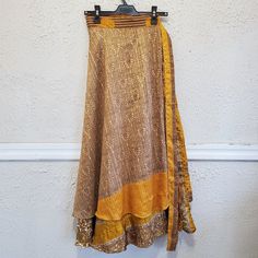 Mexicali Blues Magic Skirt Long...To Ankle Wrap Around Color Is Mix Of Golds With Brown And White Accent Colors One Size Fits All Double Layers Of Silk, 70% Silk, 30% Viscose Made From Recycled Silk Saris Each One Is Unique In Colors And Patterns...No Two Alike. It Truly Is One Of A Kind. Can Be Worn In Many Different Ways As Dress Or Skirt, Depending On How You Wrap And Tie Card Included With Photos Of Styles It Can Be Worn In, With Link To Online Directions For Each One. New With Tags Smoke-Fr Gold Lined Skirt, Gold Lined Long Skirt, Gold Long Lined Skirt, Yellow Fitted Tiered Skirt, Fitted Yellow Wrap Skirt, Fitted Yellow Tiered Skirt, Gold Flowy Long Skirt, Gold Lined Maxi Skirt For Summer, Fitted Yellow Tiered Maxi Skirt