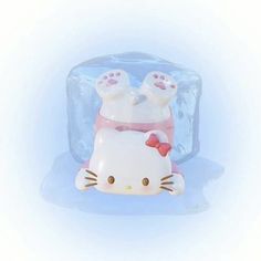 a hello kitty toy laying on top of an ice block