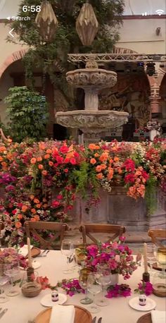 the table is set with flowers and place settings