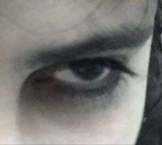 an image of the eyes of a person with long hair and black eyeliners