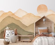 a child's bedroom with mountains painted on the wall and bed in the foreground