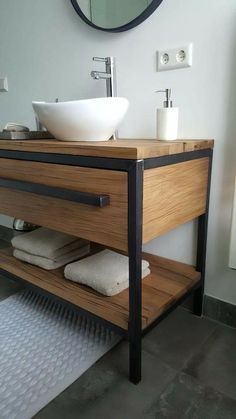 a bathroom with a sink, mirror and rugs on the floor in front of it