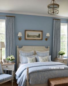 a bedroom with blue walls and white furniture