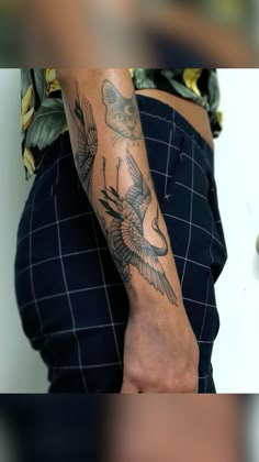 a person with a bird tattoo on their arm