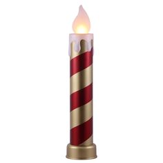 a red and gold lit candle with a flame on the top that is shaped like a candy cane