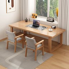 a laptop computer sitting on top of a wooden desk in front of a large window