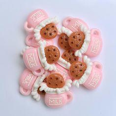 six pink and white teddy bears with cookies in the shape of heart shaped candies