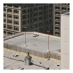 an aerial view of a parking lot with cars parked on it and the words arctic monkeys the car