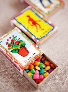 three small boxes filled with candy sitting on top of a table