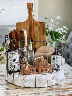 a basket filled with personalized items sitting on top of a wooden table next to a cutting board