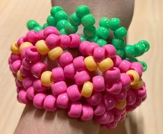 a person's hand holding a bunch of colorful beads