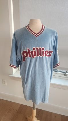 an old philadelphia phillies baseball jersey on a mannequin in front of a window