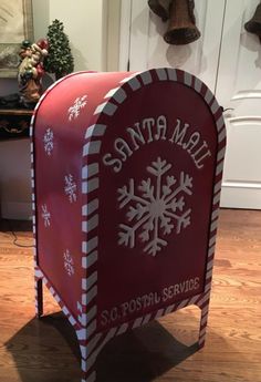 a red mailbox decorated with snowflakes and the words santa mail on it