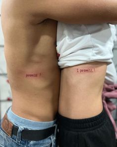 two people with tattoos on their stomachs, one has the word'i promise '