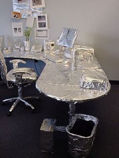 an office desk covered in silver foil