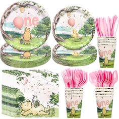 winnie the pooh birthday party supplies including plates, napkins and cups with balloons