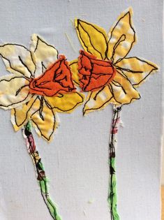 two yellow and red flowers on a white piece of paper