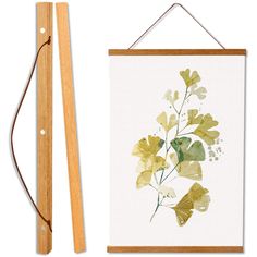 a painting and a wooden frame on a white background next to a pair of scissors