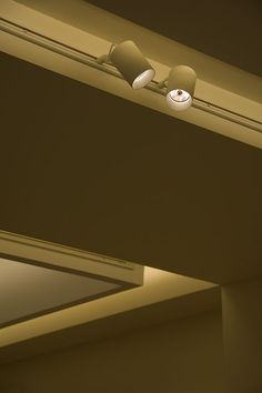 two lamps are on the ceiling in an empty room