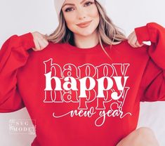 a woman wearing a red sweatshirt with the words single and loving it printed on it