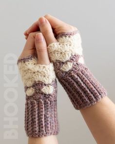 a woman's hand is holding the wrist of her knitted arm warmer