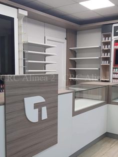 an empty pharmacy room with shelves and counters