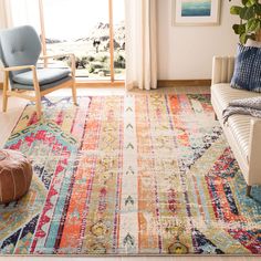 a living room filled with furniture and a colorful rug