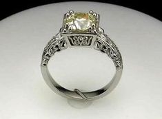 a fancy yellow diamond ring with filigree accents