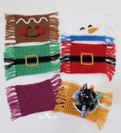 four crocheted christmas stockings with decorations on them