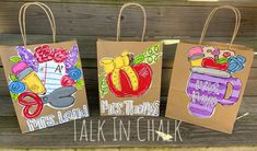 three paper bags with different designs on them