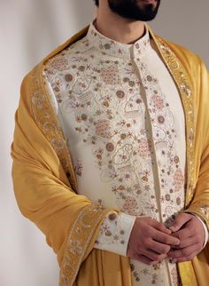 Editor's Note Featuring Hand Embroidered Placement Sherwani With Ivory Moti Work, With Dabka Highlighting. Paired With Embroidered Mustard Stole And Ombre Champagne Safa, Matching Kurta And Churidar. Fabric: Linen Silk Color: Ivory Component: Sherwani, Kurta, Churidar, Safa, Stole Care: Dry Clean Only About the Designer After establishing himself as the leading couturier in the industry of menswear, Jatin Malik went on to explore luxury footwear. You can order online these amazingly designed han Stole For Men, Jatin Malik, Muslim Men Clothing, Indian Wedding Clothes For Men, Moti Work, Sherwani Groom, Wedding Outfit Men, Indian Wedding Outfits, Satin Color