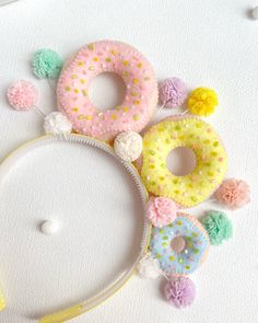 there are many donuts on the table with pom - poms around them