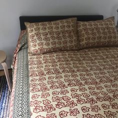 a bed with red and white bedspread on top of it