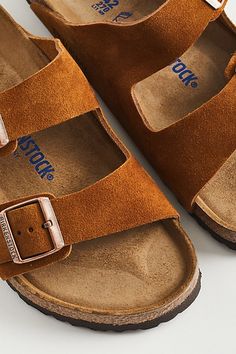 The classic Birkenstock Arizona sandals with adjustable strap detailing crafted from premium suede. Fitted with a soft footbed with a cork layer and finished with a durable EVA outsole. Features Classic Birkenstock Arizona sandals Molded footbed Textured rubber outsole Content + Care Suede, EVA Spot clean Imported Size + Fit Birkenstock regular width Fits like a medium D width | Birkenstock Arizona Soft Footbed Sandal in Light Brown at Urban Outfitters Tan Birkenstocks, Birkenstock Sandals Arizona, Footbed Sandals, Birkenstock Arizona, Birkenstock, Light Brown, Cork, Arizona, Urban Outfitters