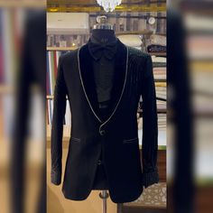 Make an edgy statement with our BLACK EMBROIDERED suit designed thoughtfully for the modern  man. A fusion staple fit for every occasion, adds the right amount of cultural twist to the western silhouette. Color: Black  Garment Type: Indo Western Neck: tuxedo Fabric: Micro Velvet Embroidery: Zari work with sequin embroidery The Product Price is inclusive of: 1 Indo-Western and 1 Trouser Style Bottom and 1 shirt Product color may slightly vary due to photographic lighting sources or your screen settings. ~We provide fully stitched outfits as per your measurements ~Outfits can be customised in any colours For customisation please contact  ~We provide worldwide shipping ~You choose we design. ~High quality dresses no replicas only hand embroidery ~Image is only for reference purpose ~Disclaime Black Fitted Bandhgala For Semi-formal Occasions, Black Tuxedo Set For Winter, Fitted Black Unstitched Suit For Semi-formal Occasions, Formal Black Fitted Bandhgala, Designer Winter Tuxedo For Party, Designer Winter Party Tuxedo, Black Tuxedo For Party Wear And Festive Occasions, Black Tuxedo For Party Wear, Black Fitted Tuxedo Bandhgala